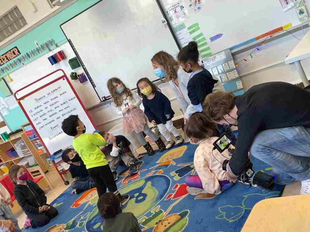 A cameraman of The Balancing Act shooting kids in a class of The French American Academy